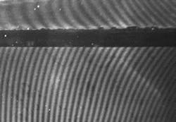 Figure 4. This image shows moir&eacute; patterns on multiple strips of a grating applied on a curved part. The change in the strip alignment is visually evident in the moir&eacute; pattern image.