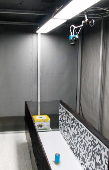 The team mounted a MotionBLITZ EoSens Cube6 above a wind tunnel with parallel vertical walls showing artificial 2D patterns. The randomized checkerboard serves as visual stimulus.