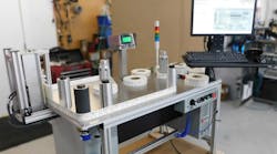 Figure 1: To inspect medical imaging product labels, an operator opens a label recipe on an HMI, loads a label roll onto the table, and strings it through rollers in front of a CIS line scan camera. Figure 1: To inspect medical imaging product labels, an operator opens a label recipe on an HMI, loads a label roll onto the table, and strings it through rollers in front of a CIS line scan camera.