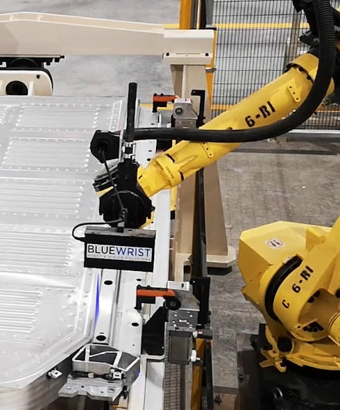Figure 2: A Keyence LJ-V7300-model 3D laser profile attached to a FANUC M-710iC robot scans an electric vehicle battery tray.