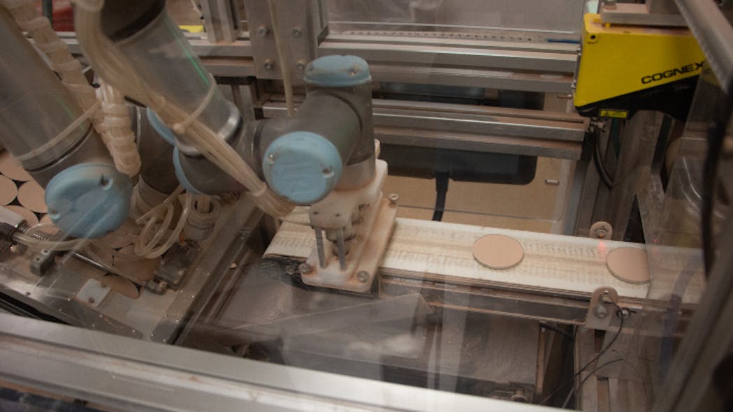 Figure 1: A Cognex DS1101 3D laser profiler inspects metal pans called godets that are filled with powdered cosmetics products.