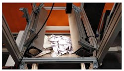 Figure 2: Two halogen lights mounted on a SPECIM Labscanner frame over a conveyor belt simulate the use of hyperspectral analysis for automated textile sorting. Figure 2: Two halogen lights mounted on a SPECIM Labscanner frame over a conveyor belt simulate the use of hyperspectral analysis for automated textile sorting.