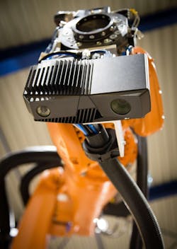 A Zivid One camera, mounted on a Kuka KR 09 robot arm, in position to scan battery parts for depalletization.