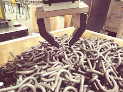 Figure 3: The 3D camera flashes a projection pattern into the bin and a collaborative robot with custom fingers from Capsen Robotics picks up a hook. Figure 3: The 3D camera flashes a projection pattern into the bin and a collaborative robot with custom fingers from Capsen Robotics picks up a hook.