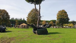 The Milrem Robotics THeMIS UGV with a tethered UAS hovering above. The Milrem Robotics THeMIS UGV with a tethered UAS hovering above.