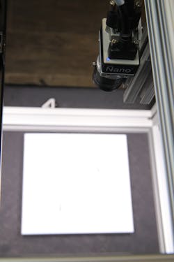 Figure 3: A Genie Nano 5G M4060 camera on fixed-mount above the picking tray images parts. Image courtesy of Vertical AIT.
