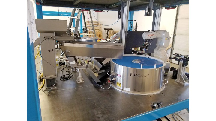 Figure 1: Metal and plastic automotive parts feed from a hopper into vibratory feeders, and then into programmable FlexiBowl feeders that separate the parts, allowing a robot to make picks. (Photos courtesy of Skye Automation.)