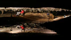 Photo by Alan Cressler shows Stephen Alvarez photographing ancient drawings in a cave in Alabama.