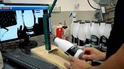 Dairy Distillery is using a visual inspection system to help employees apply labels to bottles.