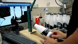 Dairy Distillery is using a visual inspection system to help employees apply labels to bottles. Dairy Distillery is using a visual inspection system to help employees apply labels to bottles.