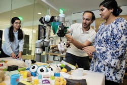 MIT researchers demonstrate FuseBot, a robotic arm and gripper, as it retrieves a hidden item from a pile. Pictured are Research Assistant Tara Boroushaki, Associate Professor Fadel Abid, and Research Assistant Nazish Naeem. (Photo courtesy of MIT.)