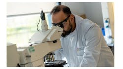Figure 1. A scientist inspecting quantum dot films using an optical microscope. Figure 1. A scientist inspecting quantum dot films using an optical microscope.