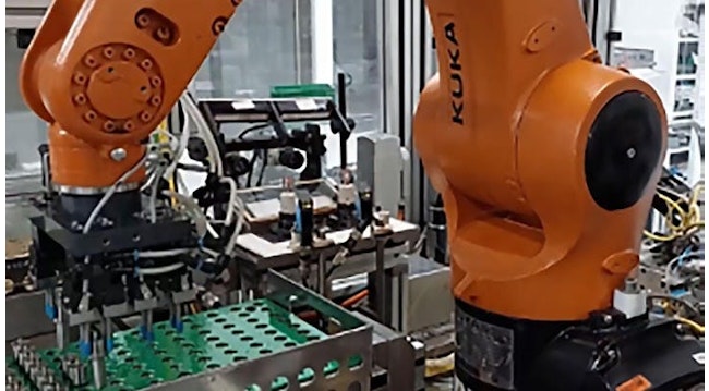 Figure 1: An industrial robot at Bosch's plant in Curitiba, Brazil, picks up injector nozzles and places them on a platform, allowing a vision system to capture images of codes engraved on the nozzles.