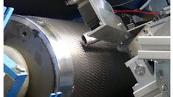 For this inspection system, a camera was mounted in a IP67 rated housing to prevent damage from carbon fiber dust. The camera and housing, along with an LED lighting unit, was mounted on a rack so the research team could manually position it to inspect card clothing used in textile carding machines.. For this inspection system, a camera was mounted in a IP67 rated housing to prevent damage from carbon fiber dust. The camera and housing, along with an LED lighting unit, was mounted on a rack so the research team could manually position it to inspect card clothing used in textile carding machines..