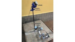 Figure 1: In an experimental setup, a robot arm moves a laser scanner over a crack in a concrete specimen, while a LiDAR sensor collects information on the surrounding environment.