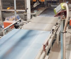 Figure 2: Two color cameras mounted above the production line inspect cement sacks for defects such as splits, cracks, and spills. Figure 2: Two color cameras mounted above the production line inspect cement sacks for defects such as splits, cracks, and spills.