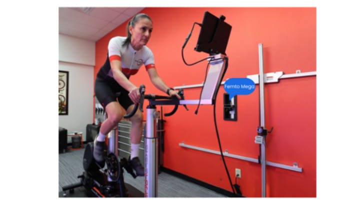A cyclist prepares for a fitting session using the Velogic Studio bike fitting system.