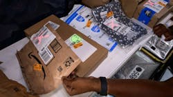 Figure 2: The Vision-Assisted Package Retrieval system projects a green 'O' on packages to be delivered at a stop and a red 'X' on all other packages. Figure 2: The Vision-Assisted Package Retrieval system projects a green 'O' on packages to be delivered at a stop and a red 'X' on all other packages.