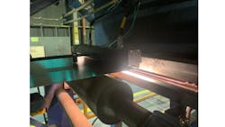 Figure 2: The engineers integrated a compact image sensor into housing and positioned it above the steel strip on the production line. They installed a ribbon light at the bottom of the steel strip, maximizing image contrast. Figure 2: The engineers integrated a compact image sensor into housing and positioned it above the steel strip on the production line. They installed a ribbon light at the bottom of the steel strip, maximizing image contrast.