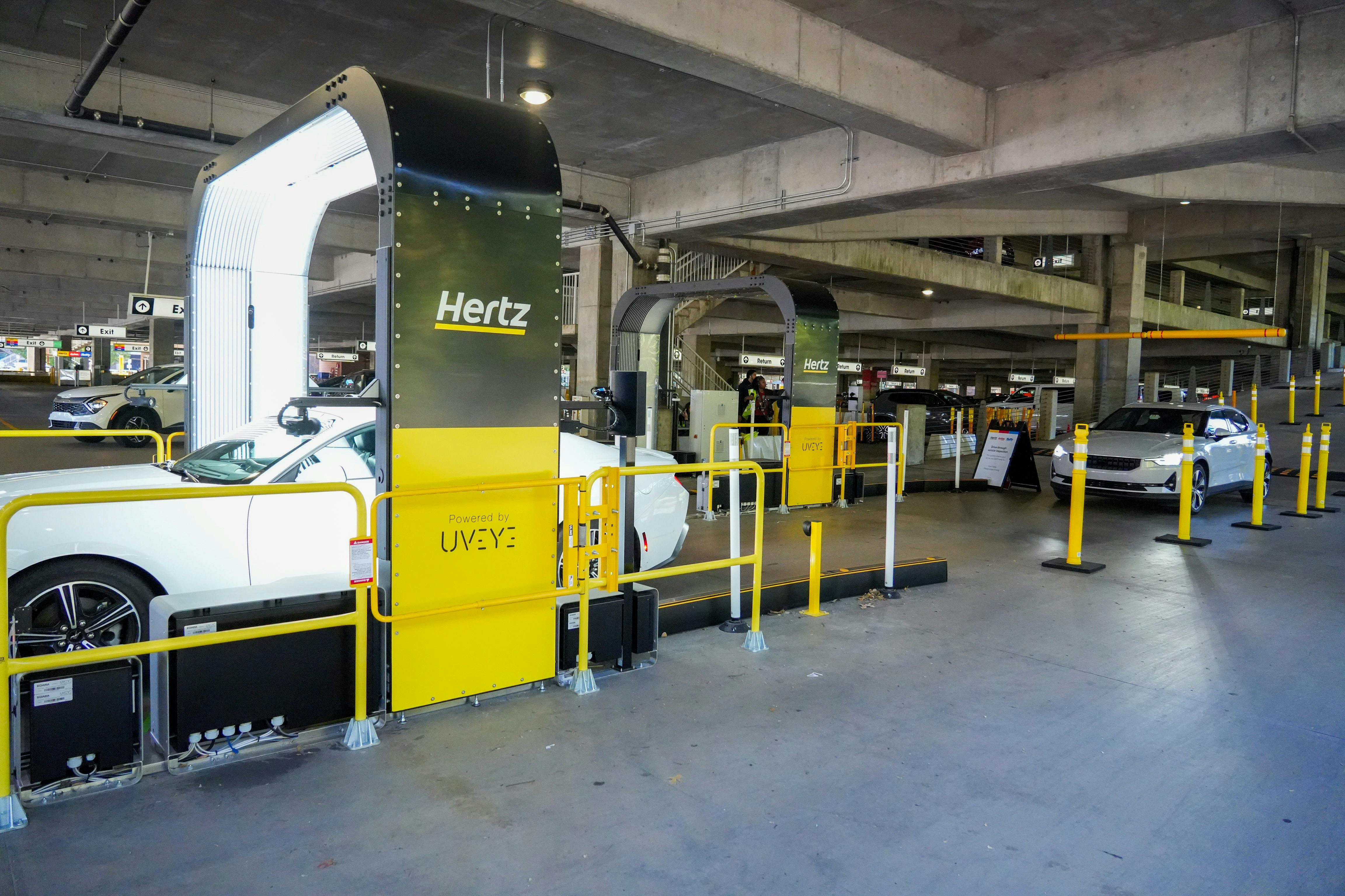 Figure 1: UVeye's rental car inspection system utilizes more than 20 cameras and AI software to perform inspections of rental vehicles in the Hertz facility at Hartsfield Airport, Atlanta, Ga.