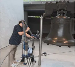 Alexander Fisher scanning the inside of the bell using a FARO robotic arm.