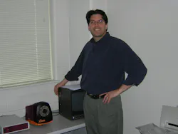 Dr. Lau and his 3DV Systems Zmini, one of the first consumer-grade indirect time-of-flight (iToF) cameras in the world and the first Zmini delivered to the United States. Photo was taken in 2004 in his lab on the UK campus. The camera is that bowling ball sized object on the table.